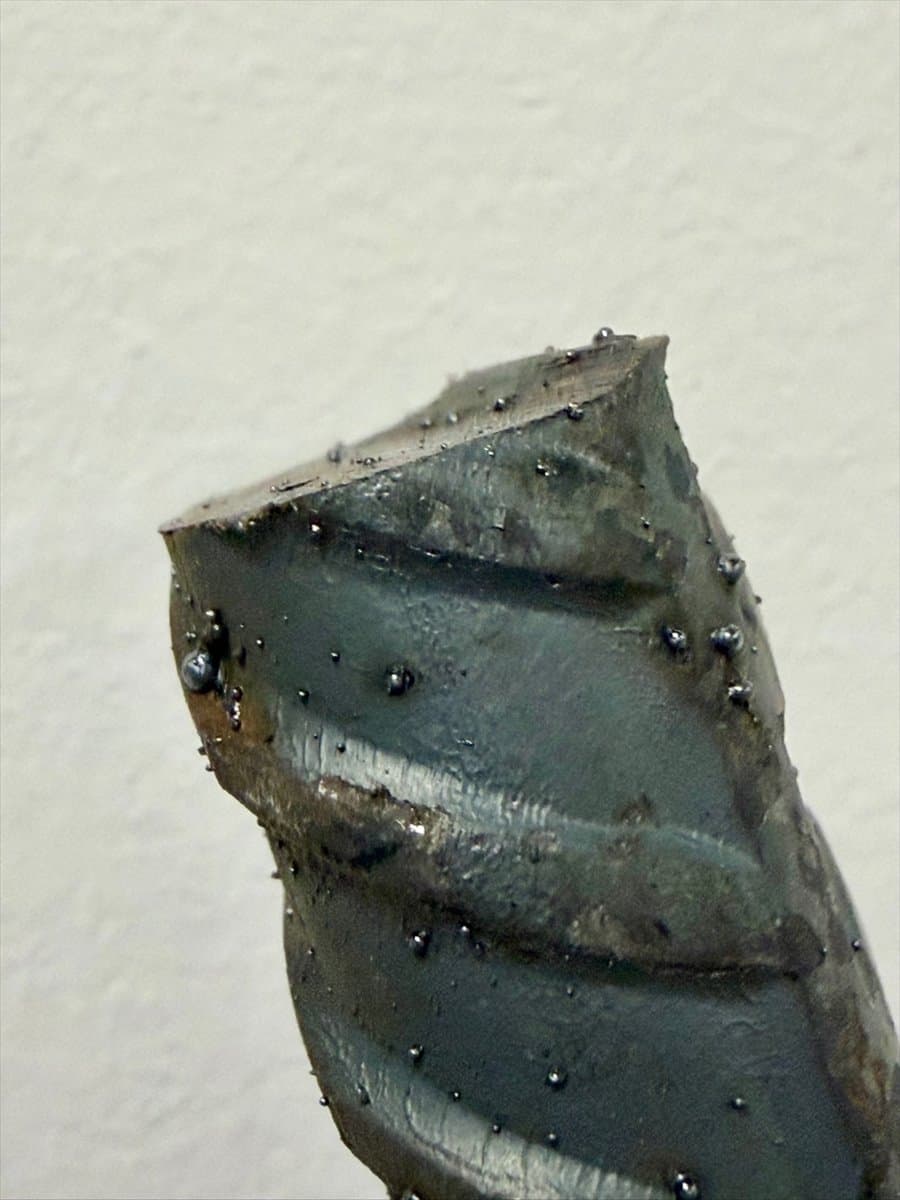 Cut end and textured surface of a rebar hand sculpture